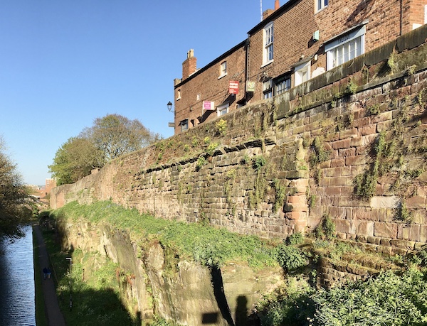 A section of the original Roman wall can be identified by its cornice protruding from the medieval wall in this view from the bridge on Northgate Street.