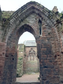A view from inside the South Eastern Chapel looking west towards the man building of St.John's. A 13th century coffin can be seen set high into the wall.