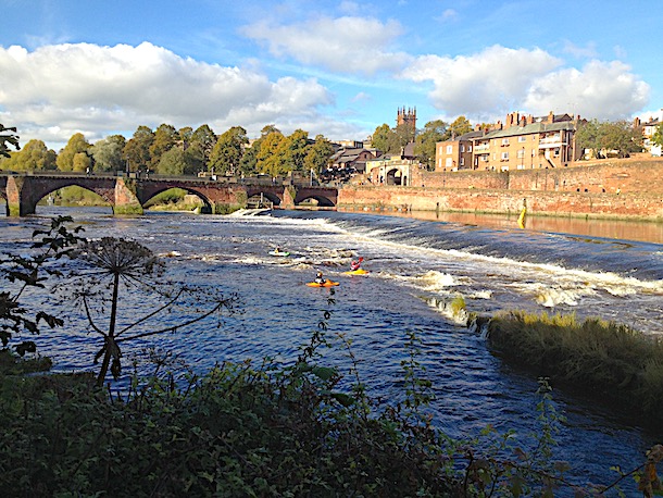 Canoeists take on the weir in front of the Old Dee Bridge